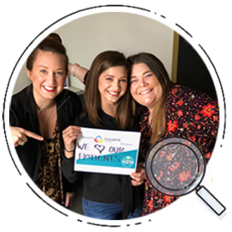 Three CareBOX employees holding a sign that says we love our patients