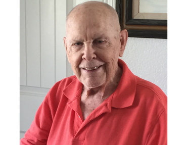 Man in red shirt smiling