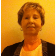 Woman with hoop earrings, black cardigan and white shirt taking a selfie