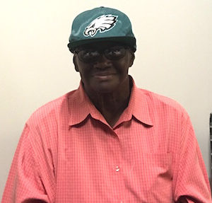 Man in Philadelphia Eagles hat smiling at camera