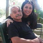 Man in blue shirt smiling with daughter