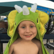 Child with a green lizard towel