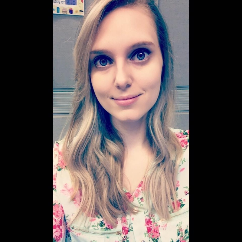 Lady with blue eyes and flower blouse smiling