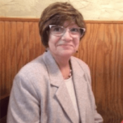 Woman in glasses and pink top smiling