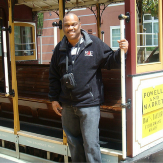 Man in jeans and black shirt on a trolley