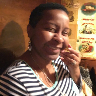 Woman in black and white striped shirt smiling