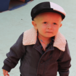 Little boy in a white and black hat with a coat