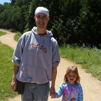 Man in UT Sweater on a walk with daughter