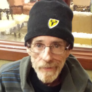 Man in black beanie and glasses