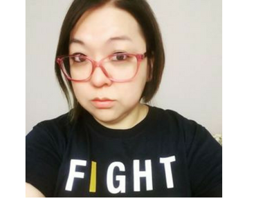 Woman with Fight Cancer shirt and red frame glasses