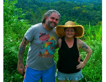 Man with woman in big hat in the outdoors