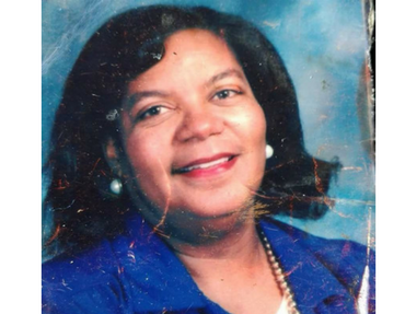 Woman with pearl earrings in a blue blazer