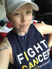 Woman with white cap and Fight Cancer Shirt