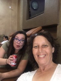 Two woman smiling at a salon with a dr. pepper