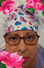 Woman in heart cap and purple framed glasses with a flower filter